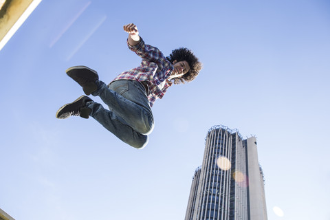 Young man jumping in the air stock photo