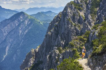 Germany, Bavaria, Young woman running in the mountains - MRF01687