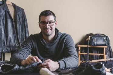 Portrait of smiling man in leather workshop - SKCF00246