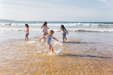 Four children splashing with water at seaside - MGOF02853