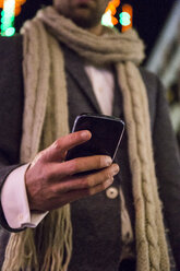 Close-up of man using his cell phone at night - ABZF01822