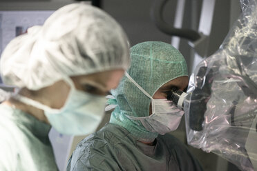 Neurosurgeon and operating room nurse during an operation - MWEF00115