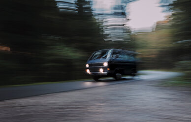 People carrier driving on country road in the evening - WVF00828