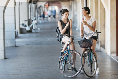 Two young women with bicycles eating icecream - ALBF00118
