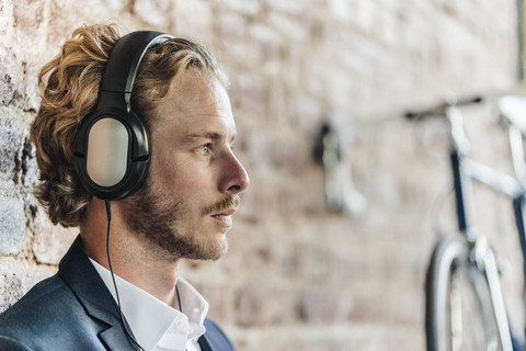 Businessman wearing headphones stock photo