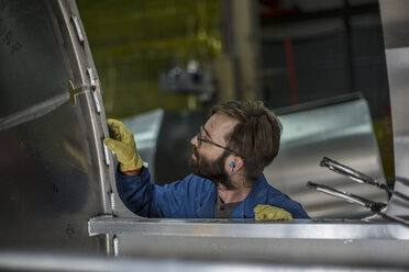 Man inspecting steel container in factory - ZEF12703