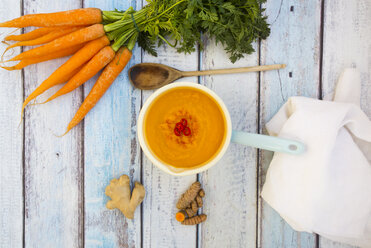 Saucepan of carrot curcuma soup with ginger and chili and ingredients - LVF05851
