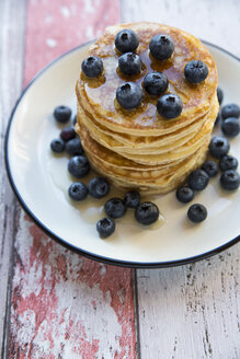 Dish with pile of pancakes and blueberries with maple sirup - SARF03166