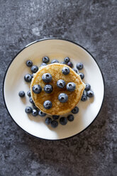 Dish with pile of pancakes and blueberries with maple sirup - SARF03167