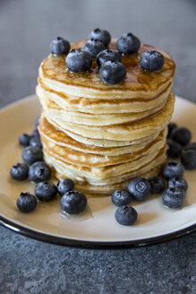 Dish with pile of pancakes and blueberries with maple sirup - SARF03168