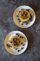 Two dishes with pancakes, blueberries and maple sirup - SARF03169