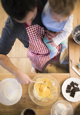 Vater und kleiner Junge in der Küche beim Backen eines Kuchens, lizenzfreies Stockfoto