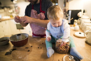 Father and baby boy in kitchen baking a cake - HAPF01345