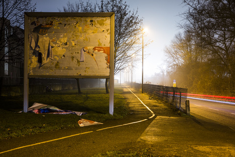 Billboard with destroyed advertising at night stock photo