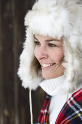 Portrait of smiling woman wearing fur cap in winter - FSF00729