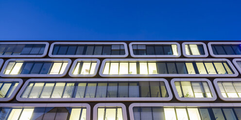 Part of facade of lighted office building in the evening - WDF03864