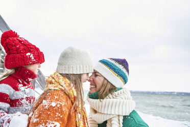 Mother and daughters having fun in winter - FSF00750