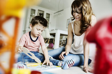 Mother and son plying in living room - JATF00957