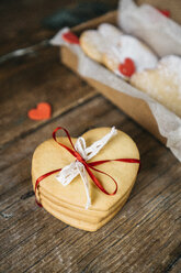 Stapel von vier herzförmigen Shortbreads mit Spitze und Schleife auf Holz gebunden - GIOF01788