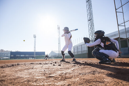 Female batter hitting the ball during a baseball game - ABZF01862