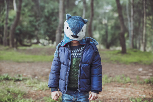 Boy wearing funny wooly hat in forest - RTBF00625