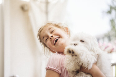 Happy girl playing with dog - JOSF00605