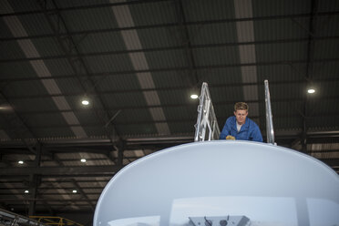 Technician in truck manufacture working on truck container - ZEF12792