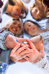Four friends joining hands, close-up - MGOF02941