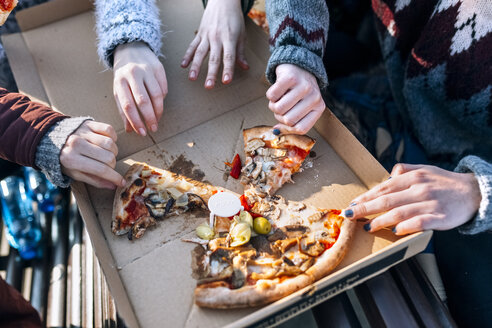 Vier Freunde essen Pizza im Freien, Teilansicht - MGOF02960