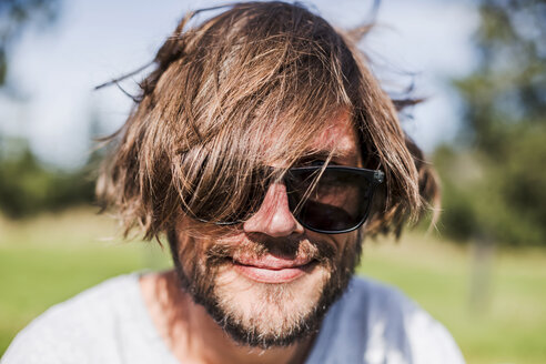 Portrait of a man with unkempt hair wearing sunglasses - WVF00832