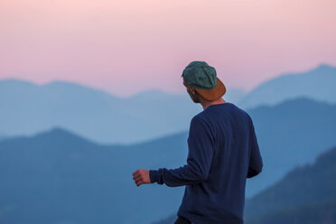 Austria, Mondsee, Mondseeberg, rear view of man wearing a basecap at dusk - WVF00848