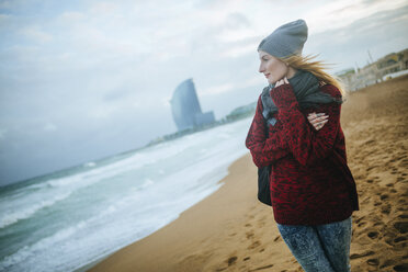 Spanien, Barcelona, junge Frau am Strand im Winter - KIJF01184