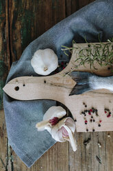 Sea Bream on a wooden board with pepper, garlic and rosemary - GIOF01851
