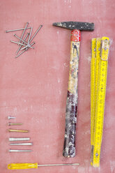 Used tools, nails and screws on pink ground - CMF00639