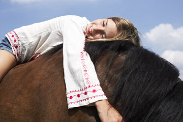 Happy girl lying on horseback - FSF00779