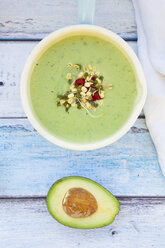 Saucepan of avocado cucumber soup garnished with sprouts - LVF05859