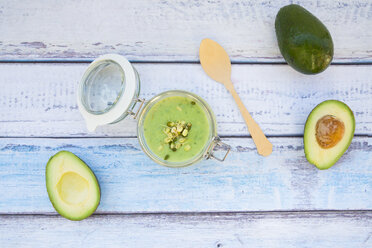 Preserving jar of avocado cucumber soup garnished with sprouts - LVF05860