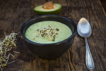 Bowl of avocado cucumber soup garnished with sprouts - LVF05864