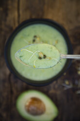 Spoon of avocado cucumber soup and sprouts - LVF05865