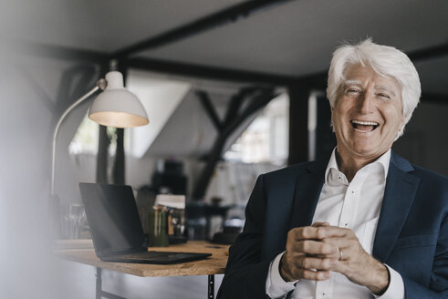 Portrait of laughing senior businessman in his office - KNSF01019