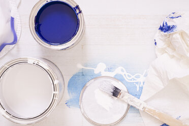 Used paint brush and paint tins with blue and white varnish - CMF00642