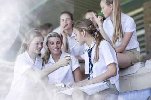 Female high school students smoking a cigarette - ZEF12808