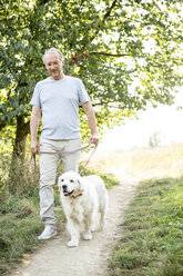 Senior man going walkies with dog - WESTF22703