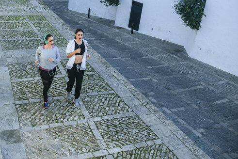 Junge Frauen joggen auf der Straße - KIJF01237