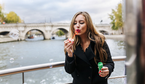 Paris, France, portrait of woman blowing soap bubbles stock photo