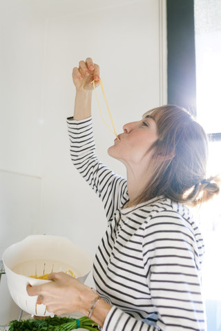 Young woman cooking pasta stock photo