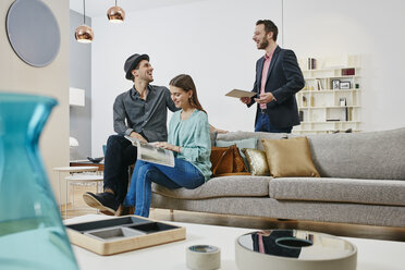 Couple talking to salesman in furniture store - RORF00599