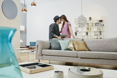 Couple choosing furniture in shop, using digital tablet stock photo