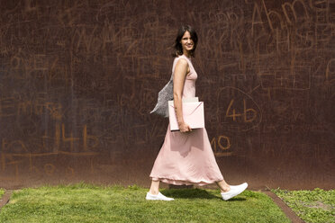 Portrait of young woman in front of corten wall - LMF00634