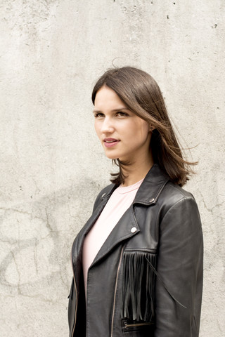 Portrait of young woman wearing black leather jacket stock photo